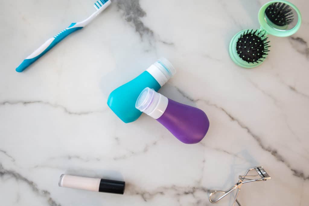 toothpaste bottles with toothbrush makeup and hair brush
